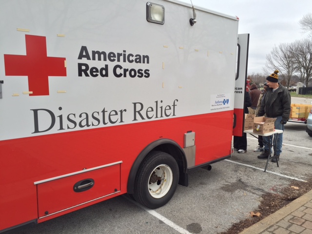 Volunteers load sand bags for the River Des Peres Levee
